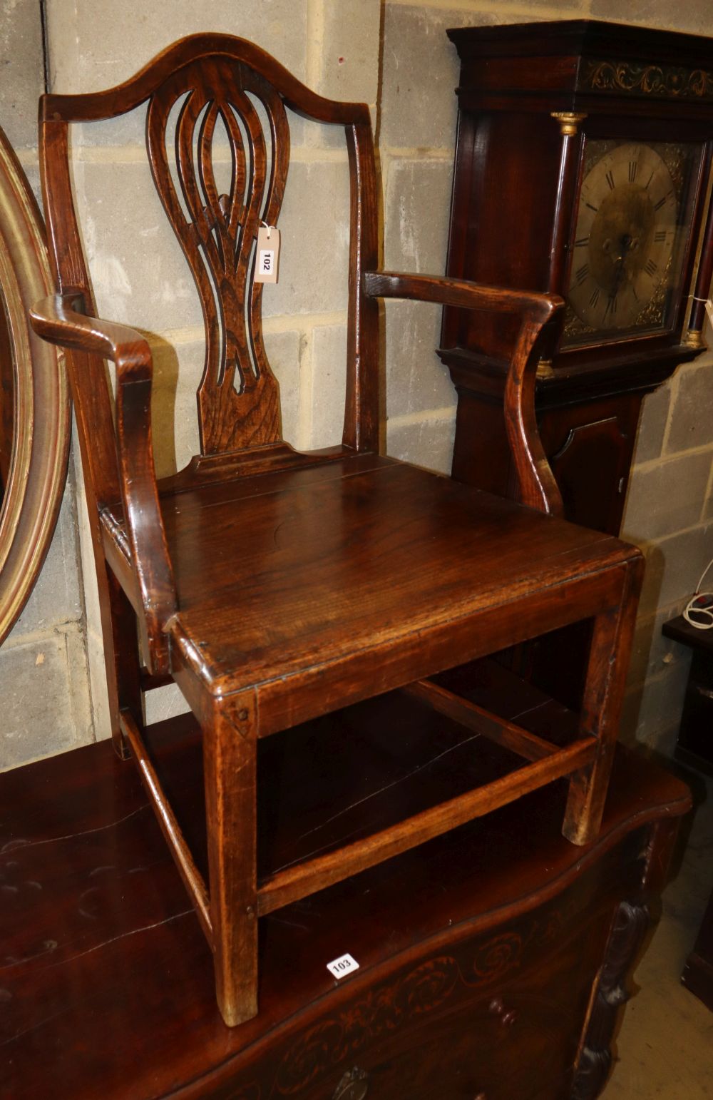 A George III provinical oak elbow chair